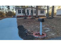Charming single-story home with a well-manicured front yard and a cozy mailbox at 162 Deer Vw, Sanford, NC 27332