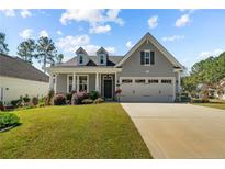 Charming one-story home featuring a well-manicured lawn and an attached two-car garage at 45 Glen Bend Ct, Spring Lake, NC 28390