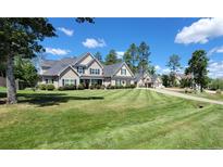 Inviting two-story home featuring manicured lawn and classic architectural details at 105 Lakewood Vw, Sanford, NC 27332