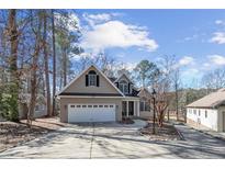 Charming home featuring a two-car garage, extended driveway, and well-manicured landscaping at 6090 Dunes Dr, Sanford, NC 27332