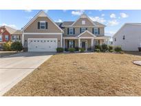 Charming two-story home with a two-car garage and covered front porch at 30 Yaupon Cir, Spring Lake, NC 28390