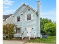 Charming two-story home featuring a light blue facade, complemented by white trim and a well-maintained front yard at 8037 Perry Creek Rd, Raleigh, NC 27616