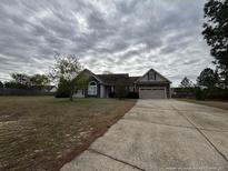 Charming single-story home featuring a two-car garage, well-maintained lawn, and neutral color scheme at 41 Truman Ln, Cameron, NC 28326