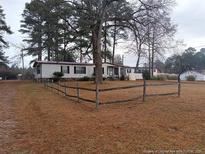 Cozy home with charming wood fence and mature trees in a quiet location at 22176 Nc 24-27, Cameron, NC 28326