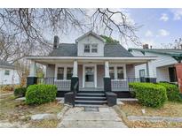 Charming home featuring a cozy covered porch and well-maintained landscaping at 321 Coleman Ave, Rocky Mount, NC 27801