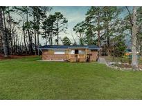 Charming brick home with a manicured lawn and inviting front porch at 3524 June Rd, Sanford, NC 27332