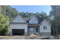 Charming two-story home featuring a side-entry garage and classic architectural details at 45 Pine Hill Ct, Spring Lake, NC 28390