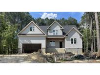 Charming new construction home with gray siding, attached garage, and unfinished landscaping at 45 Pine Hill Ct, Spring Lake, NC 28390
