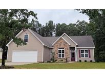 Beautiful single-Gathering home featuring stone accents, neutral siding, a two-car garage, and a well-manicured lawn at 261 River Falls Rd, Sanford, NC 27332