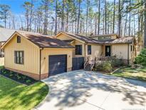 Charming single-story home with a well-manicured lawn, attached garage, and mature trees at 306 Harbor Trace, Sanford, NC 27332