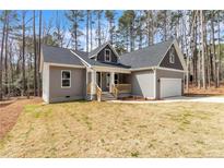 Charming, newly constructed home with gray siding, black roof, and attached garage at 5115 Cardinal Cir, Sanford, NC 27332