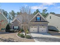 Charming two-story home featuring a two-car garage, stone accents, and lush landscaping at 1031 Micah'S N Way, Spring Lake, NC 28390