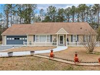 Charming one-story home featuring an attached garage and a manicured front yard with a walkway to the front door at 2123 Detroit Blvd, Sanford, NC 27332