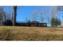 Charming one-story home featuring brick facade, metal roof, and a well-maintained front yard at 2957 Cypress Church Rd, Cameron, NC 28326