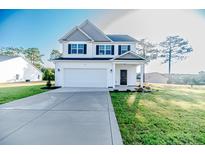 Charming two-story home featuring a two-car garage and well-manicured lawn at 30 Blackgum Ct, Spring Lake, NC 28390