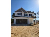 Charming two-story home featuring black shutters, a covered entryway, and an attached two car garage at 30 Blackgum Ct, Spring Lake, NC 28390