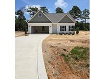 Charming single-story home features a two-car garage, neutral siding, and a welcoming front entrance at 52 Blackgum Ct, Spring Lake, NC 28390