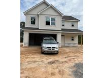 A charming two-story home featuring a spacious garage and classic design at 228 Dove Rd, Cameron, NC 28326