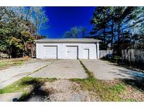 Spacious detached garage with multiple bays and a wide concrete driveway provides ample parking at 488 Hall Rd, Erwin, NC 28339
