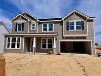 Charming two-story home with an attached two car garage and neutral siding at 104 Steeple Rdg, Cameron, NC 28326