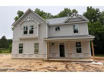 Charming two-story home with light gray siding, gabled roof, and a welcoming front porch at 1945 Cranes Creek Rd, Cameron, NC 28326