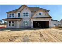 Two-story home under construction featuring a spacious two-car garage and a classic roofline at 32 Adelina Grove Ln, Cameron, NC 28326