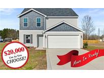 Charming two-story home featuring a gray exterior, attached garage, and well-maintained front yard at 41 Aldermann (Lot 2) Ct, Dunn, NC 28334