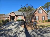 Beautiful single-story brick home with a well-manicured lawn and a long driveway at 561 Anderson Creek Dr, Spring Lake, NC 28390