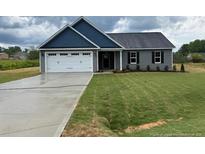 Charming single-story home with a well-manicured lawn, and a two car garage at 161 Jones Creek Ln, Lillington, NC 27546