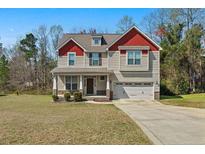 Charming two-story home with neutral siding, red accent trim, and a two-car attached garage at 178 Tun Tavern Dr, Cameron, NC 28326
