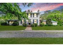 Charming two-story home with a brick pathway, green lawn, beautiful landscaping, and symmetrical design at 2007 Windmill Dr, Sanford, NC 27330