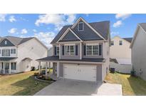 Charming two-story home features a two-car garage, covered porch, and beautifully landscaped front yard at 91 Bicentennial Way, Cameron, NC 28326
