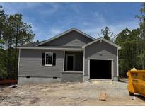 New construction home featuring gray siding, black shutters, and an attached one car garage at 182 Horse Trot Ln, Sanford, NC 27332