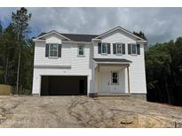 Charming two-story home with attached garage and classic curb appeal at 28 Horse Trot Ln, Sanford, NC 27332
