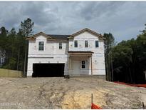 New construction home featuring a two-car garage and covered front porch at 28 Horse Trot Ln, Sanford, NC 27332