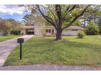 Charming single-story home with brick accents, large front yard, and mature shade trees at 107 Pandora Cir, Erwin, NC 28339