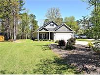 Charming single-story home with well-maintained lawn and inviting front porch with black shutters at 120 Will Lucas Rd, Linden, NC 28356