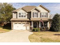 Charming two-story home with stone accents, a well-manicured lawn, and an attached two-car garage at 186 Kentucky Derby Ln, Lillington, NC 27546