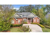 Charming red brick home with lush landscaping and inviting front porch at 30 Spring Pond Ln, Spring Lake, NC 28390