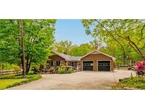 Charming single-story brick home featuring an attached two-car garage and well-manicured landscaping at 9301 Nc 27, Lillington, NC 27546
