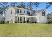 Charming two-story home featuring a landscaped yard, covered porch, and attached two-car garage at 354 Timber Skip Dr, Spring Lake, NC 28390