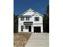 New two-story home featuring white siding, black shutters, and an attached two-car garage at 142 Horse Trot Ln, Sanford, NC 27332