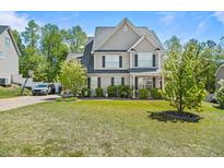 Charming two-story home with well-maintained lawn, landscaping, and traditional architectural details at 439 Colonist Pl, Cameron, NC 28326