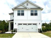 Charming two-story home with a white exterior, well-maintained lawn, and a two car garage at 156 Southern Estates Dr, Sanford, NC 27330