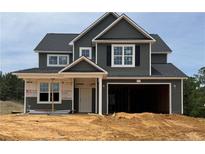 New two-story home with gray siding, black shutters, and an attached two-car garage at 279 Harborwood St, Lillington, NC 27546