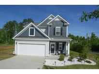 Charming two-story home features a well-manicured front yard and a welcoming entrance at 500 Lionheart Ln, Sanford, NC 27330