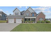 Beautiful two-story home featuring well-manicured landscaping and a three-car garage at 12 Ballentyne Ct, Sanford, NC 27332