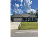 Charming one-story brick home with a two-car garage and well-manicured lawn at 78 Falls Of The Cape Dr, Lillington, NC 27546