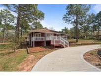 Charming single-story home featuring a welcoming front porch and a long, curved driveway at 201 Sierra Trl, Spring Lake, NC 28390