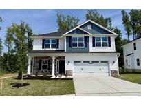 Charming two-story home with a two-car garage and beautiful modern blue and white siding at 335 Bishop Ln, Sanford, NC 27330